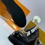 Black Patent Leather Mules with Gold-Tone Emblem