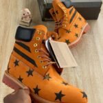 Orange Leather Boots with Black Star Pattern Design