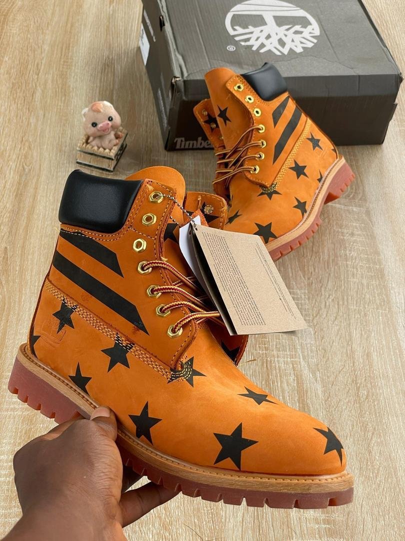 Orange-Leather-Boots-with-Black-Star-Pattern-Design.jpg Orange Leather Boots with Black Star Pattern Design - Image 1